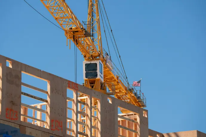 Construction crane over an unfinished building.